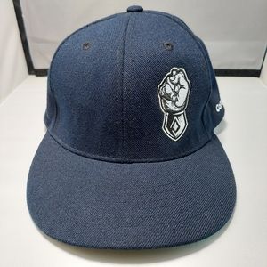 Magic headwear navy with fist design corefast snap back hat.